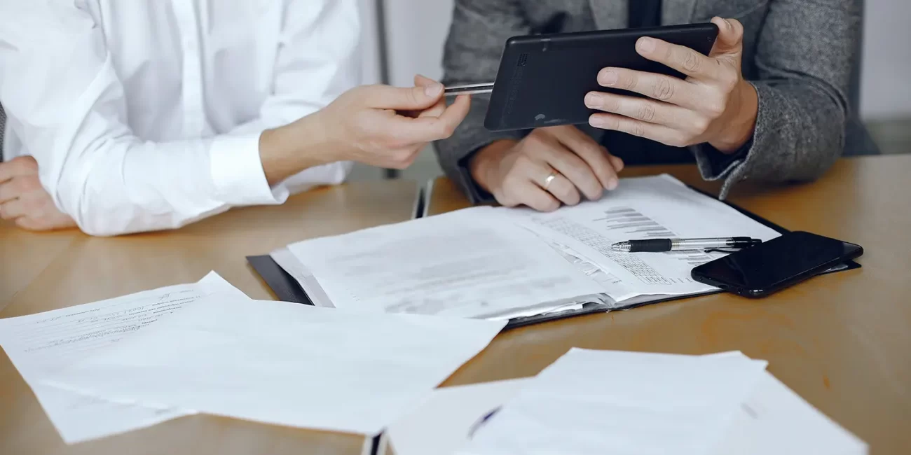 Consultores a analisar documentos sobre as novas regras do ajuste direto em contratação pública